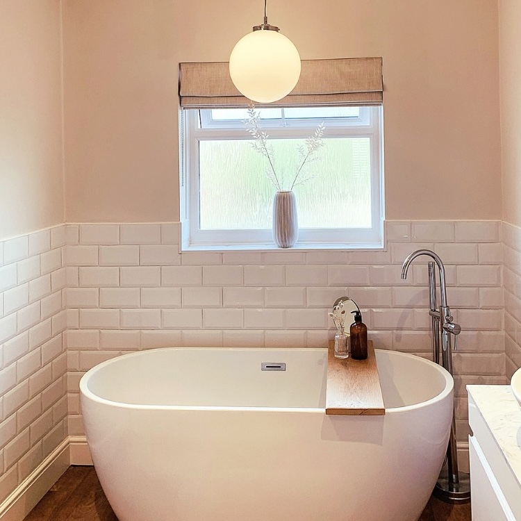 A bathroom with a new light fixture